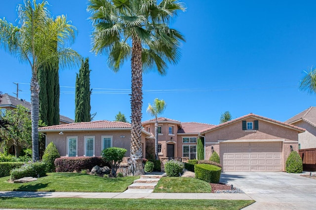 3081 Serena Ave, Clovis, CA 93619 - mediterranean / spanish home with stucco siding, an attached garage, a tiled roof, and driveway