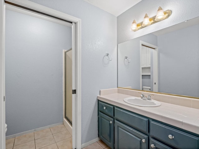 474 E Alluvial Ave Unit 139, Fresno, CA 93720 - full bathroom with toilet, vanity, a shower stall, and tile patterned floors