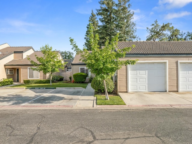 474 E Alluvial Ave Unit 139, Fresno, CA 93720 - view of front of house with a tiled roof and uncovered parking