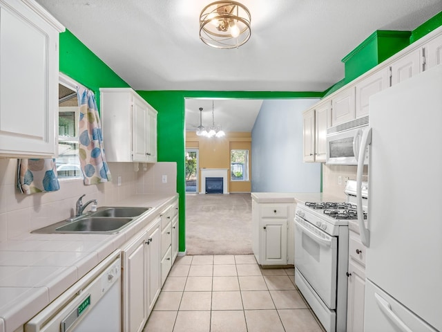 474 E Alluvial Ave Unit 139, Fresno, CA 93720 - kitchen with white appliances, tile counters, light carpet, white cabinets, and a sink