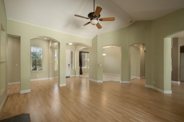 1698 E Wallington Ln, Fresno, CA 93730 - unfurnished living room with ceiling fan, light wood-style flooring, lofted ceiling, and baseboards