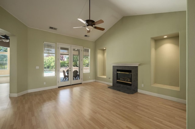 1698 E Wallington Ln, Fresno, CA 93730 - unfurnished living room featuring a ceiling fan, healthy amount of natural light, vaulted ceiling, light wood-style floors, and french doors