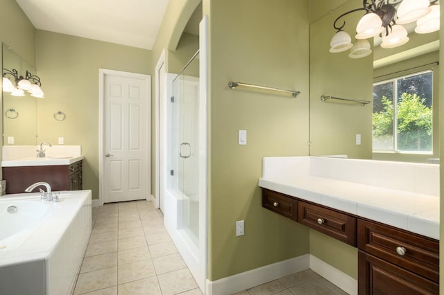1698 E Wallington Ln, Fresno, CA 93730 - bathroom with a tub, a shower with door, tile patterned floors, vanity, and baseboards