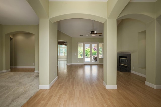 1698 E Wallington Ln, Fresno, CA 93730 - corridor with arched walkways, baseboards, and light wood-type flooring