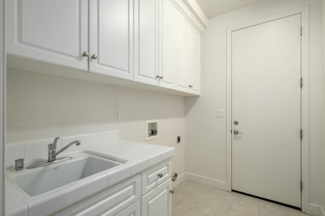 1698 E Wallington Ln, Fresno, CA 93730 - laundry area featuring cabinet space, washer hookup, electric dryer hookup, baseboards, and light tile patterned floors