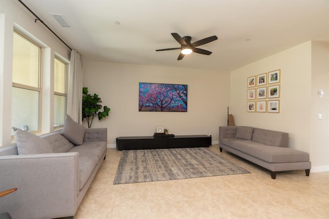 385 Fir St W, Madera, CA 93636 - living area with ceiling fan, baseboards, and tile patterned flooring