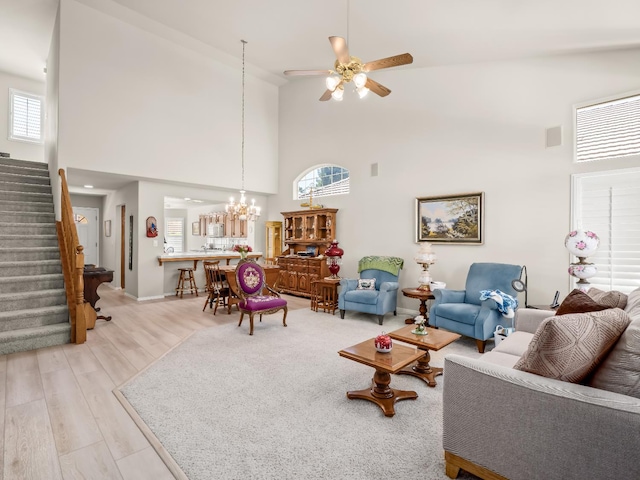 6424 N Allison Ln, Fresno, CA 93711 - living area featuring high vaulted ceiling, stairway, a ceiling fan, baseboards, and a chandelier