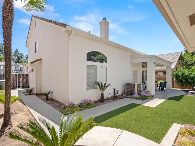 6424 N Allison Ln, Fresno, CA 93711 - rear view of house featuring a patio, stucco siding, cooling unit, and a chimney