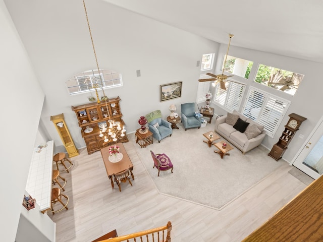 6424 N Allison Ln, Fresno, CA 93711 - living room featuring high vaulted ceiling, light wood finished floors, ceiling fan, a chandelier, and baseboards