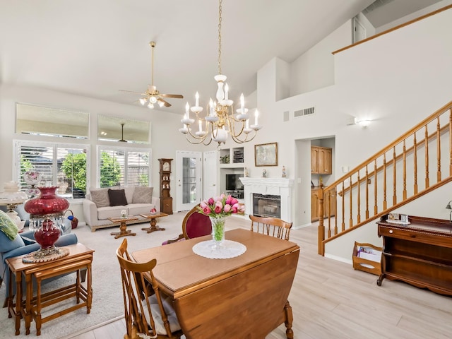 6424 N Allison Ln, Fresno, CA 93711 - dining space featuring stairs, a glass covered fireplace, light wood finished floors, ceiling fan, and a chandelier