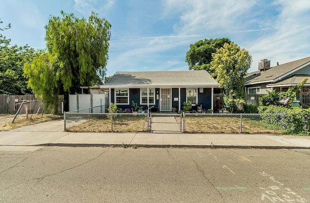 2216 E Floradora Ave, Fresno, CA 93703 - single story home with a fenced front yard, a porch, driveway, and a gate