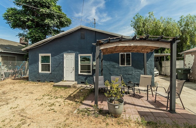 2216 E Floradora Ave, Fresno, CA 93703 - back of house with a pergola, stucco siding, and a patio area