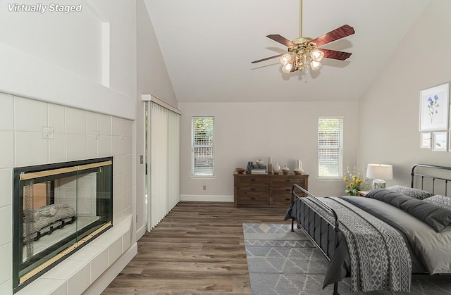 1783 E Pryor Dr, Fresno, CA 93720 - bedroom with wood finished floors, high vaulted ceiling, a tiled fireplace, baseboards, and ceiling fan