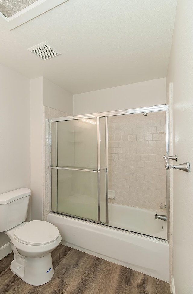 1783 E Pryor Dr, Fresno, CA 93720 - bathroom with toilet, wood finished floors, and combined bath / shower with glass door