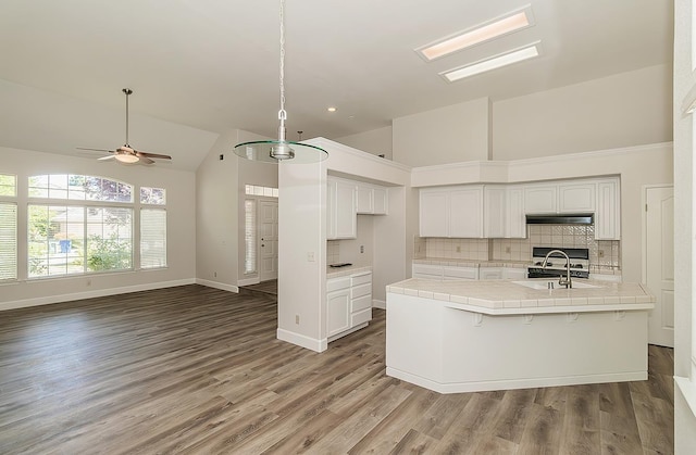 1783 E Pryor Dr, Fresno, CA 93720 - kitchen featuring a sink, tile countertops, high vaulted ceiling, under cabinet range hood, and ceiling fan
