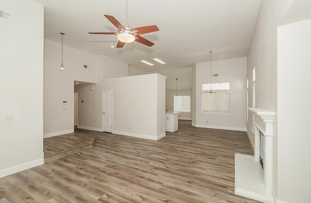 1783 E Pryor Dr, Fresno, CA 93720 - unfurnished living room with ceiling fan, wood finished floors, baseboards, and high vaulted ceiling