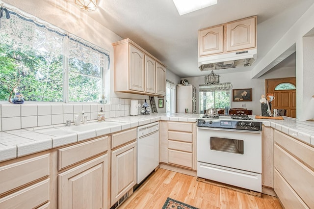 42357 Hanging Branch Rd, Shaver Lake, CA 93664 - kitchen with white appliances, light brown cabinetry, under cabinet range hood, and light wood-type flooring