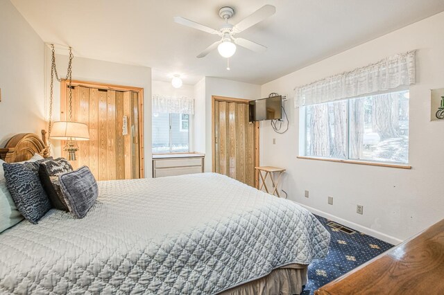 42357 Hanging Branch Rd, Shaver Lake, CA 93664 - bedroom featuring multiple closets, baseboards, carpet, and ceiling fan