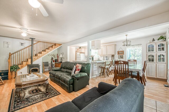 42357 Hanging Branch Rd, Shaver Lake, CA 93664 - living room with a ceiling fan, stairs, and light wood-style floors