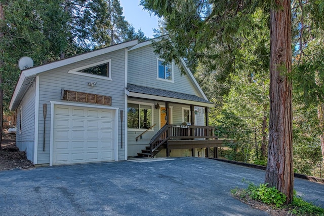 42357 Hanging Branch Rd, Shaver Lake, CA 93664 - view of front facade with a porch, driveway, and a garage