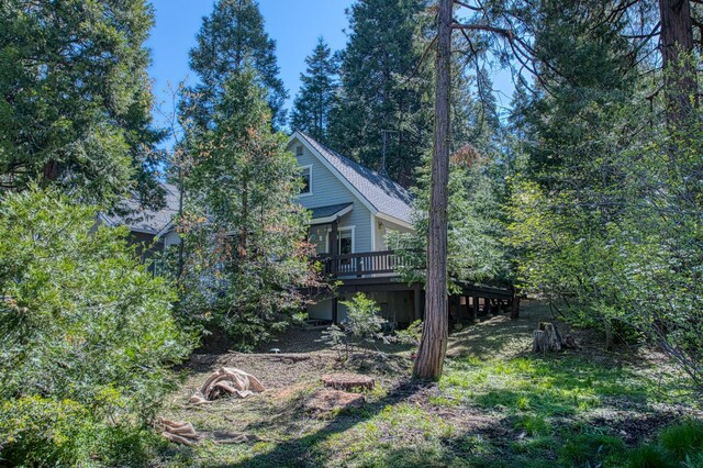 42357 Hanging Branch Rd, Shaver Lake, CA 93664 - view of side of home with a wooden deck and a shingled roof