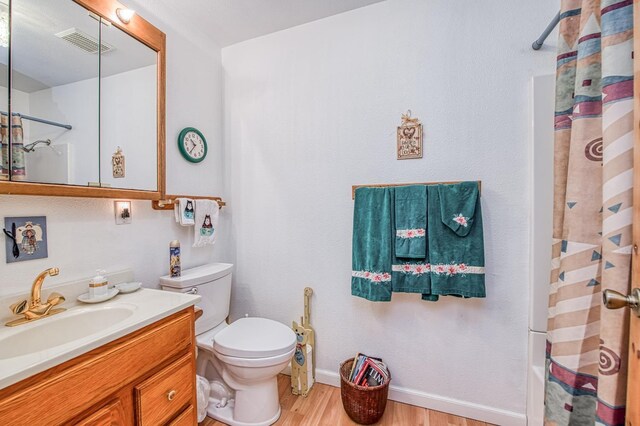 42357 Hanging Branch Rd, Shaver Lake, CA 93664 - bathroom with wood finished floors, vanity, toilet, and shower / tub combo with curtain