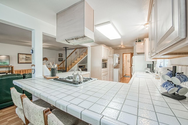 42357 Hanging Branch Rd, Shaver Lake, CA 93664 - dining space with washing machine and dryer, stairway, and light wood-style flooring