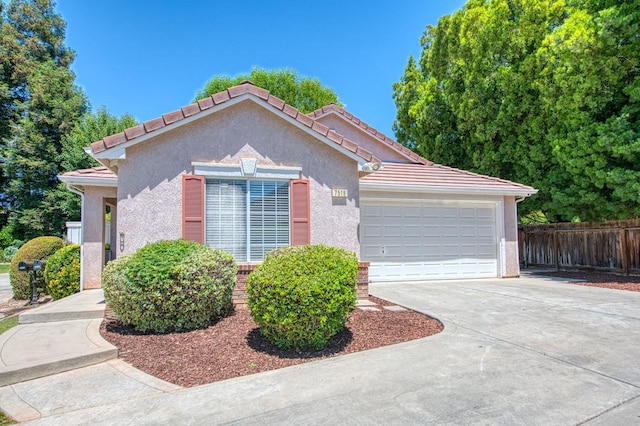 7518 N Trellis Cir, Fresno, CA 93720 - view of front of house with concrete driveway, stucco siding, an attached garage, and a tiled roof