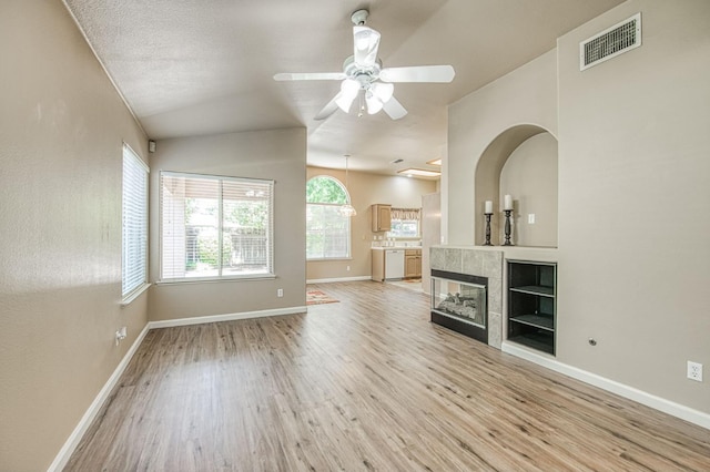 7518 N Trellis Cir, Fresno, CA 93720 - unfurnished living room featuring light wood-style flooring, ceiling fan, baseboards, and lofted ceiling