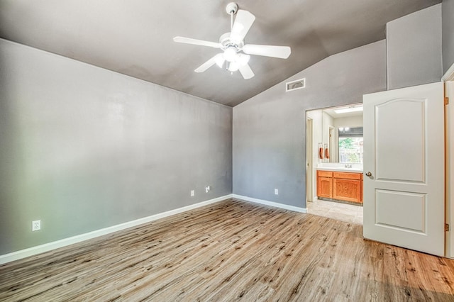 7518 N Trellis Cir, Fresno, CA 93720 - unfurnished bedroom with light wood-style floors, vaulted ceiling, baseboards, ensuite bath, and a ceiling fan