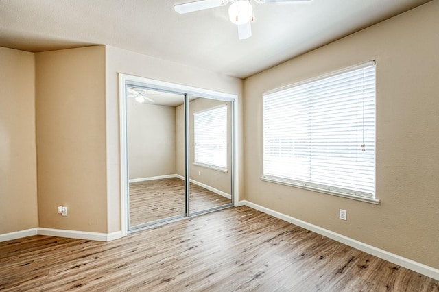 7518 N Trellis Cir, Fresno, CA 93720 - unfurnished bedroom with wood finished floors, multiple windows, and baseboards