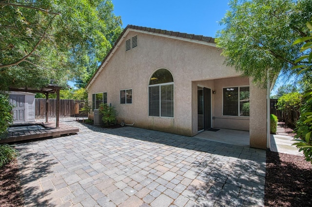 7518 N Trellis Cir, Fresno, CA 93720 - back of house featuring stucco siding, a patio area, a fenced backyard, and a deck