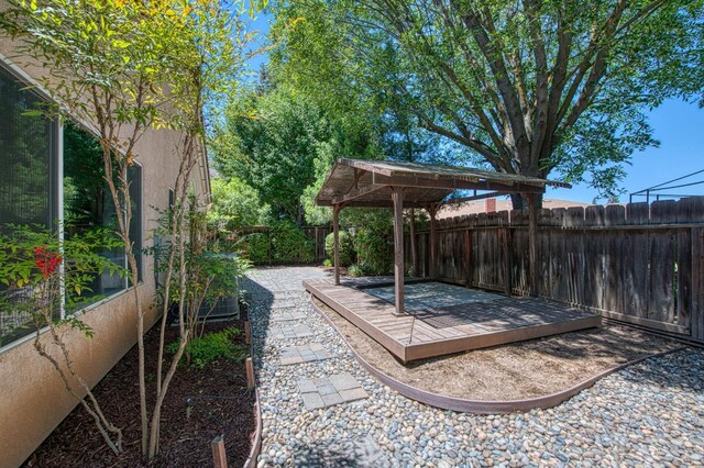 7518 N Trellis Cir, Fresno, CA 93720 - fenced backyard featuring a wooden deck and a gazebo