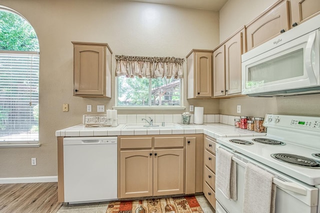 7518 N Trellis Cir, Fresno, CA 93720 - kitchen with white appliances, light brown cabinetry, healthy amount of natural light, light wood-style flooring, and a textured wall