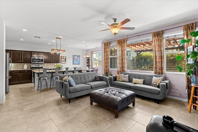 3930 Saginaw Ave, Clovis, CA 93619 - living room with recessed lighting, ceiling fan, light tile patterned floors, and baseboards