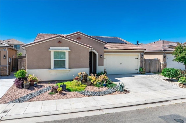 3930 Saginaw Ave, Clovis, CA 93619 - view of front facade with stucco siding, a garage, a tile roof, and solar panels
