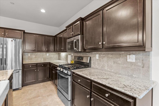 3930 Saginaw Ave, Clovis, CA 93619 - kitchen featuring appliances with stainless steel finishes, dark brown cabinets, backsplash, light stone counters, and recessed lighting