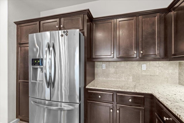 3930 Saginaw Ave, Clovis, CA 93619 - kitchen featuring stainless steel fridge with ice dispenser, dark brown cabinets, backsplash, and light stone countertops