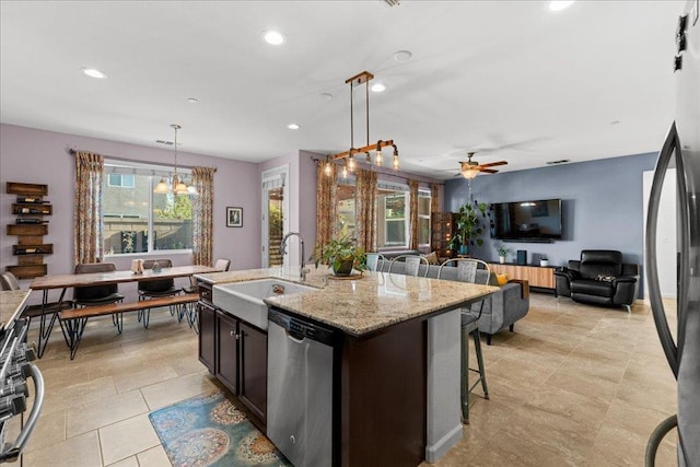 3930 Saginaw Ave, Clovis, CA 93619 - kitchen with dishwasher, a sink, ceiling fan, a kitchen breakfast bar, and pendant lighting