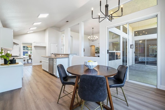 5642 W Beechwood Ave, Fresno, CA 93722 - dining area featuring a chandelier, light wood-style floors, and lofted ceiling
