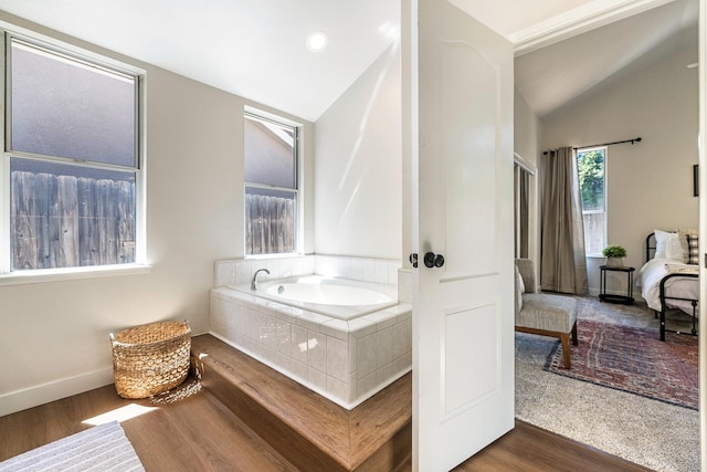 5642 W Beechwood Ave, Fresno, CA 93722 - full bathroom featuring lofted ceiling, a bath, wood finished floors, and baseboards
