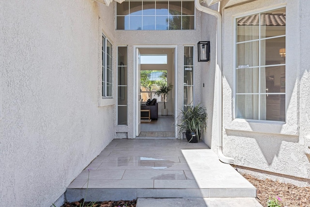 5642 W Beechwood Ave, Fresno, CA 93722 - doorway to property featuring stucco siding and a patio