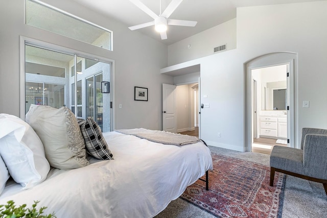 5642 W Beechwood Ave, Fresno, CA 93722 - bedroom with a towering ceiling, carpet floors, access to exterior, connected bathroom, and baseboards