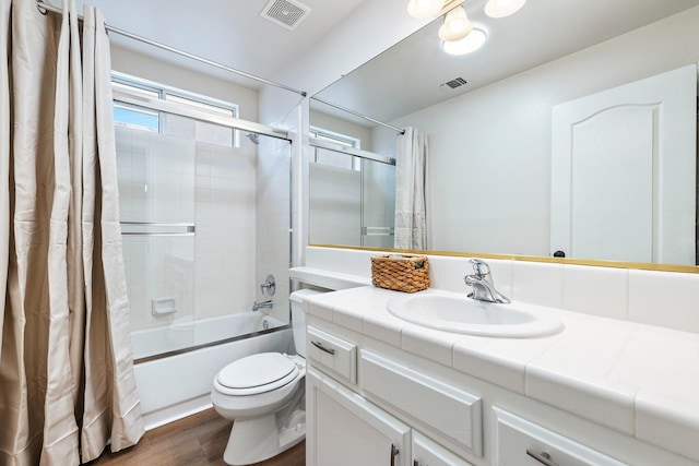 5642 W Beechwood Ave, Fresno, CA 93722 - bathroom with vanity, shower / tub combo with curtain, toilet, and wood finished floors