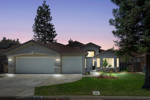 5642 W Beechwood Ave, Fresno, CA 93722 - single story home featuring a garage, concrete driveway, a tiled roof, stucco siding, and a chimney