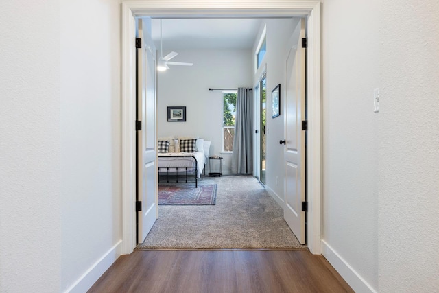 5642 W Beechwood Ave, Fresno, CA 93722 - corridor featuring wood finished floors, a textured wall, and baseboards