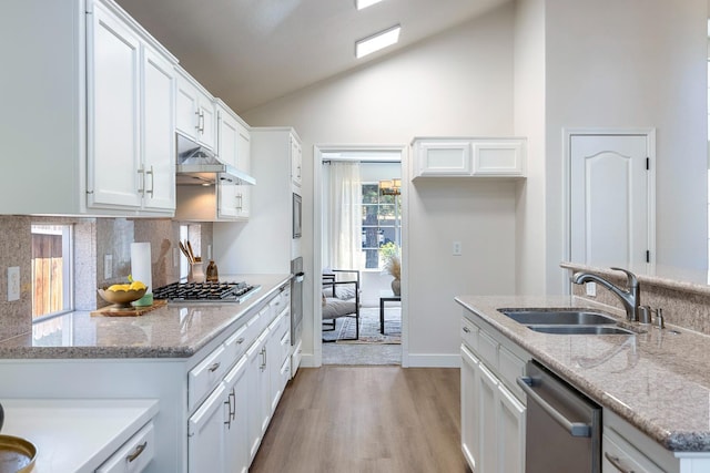5642 W Beechwood Ave, Fresno, CA 93722 - kitchen featuring stainless steel appliances, a sink, light wood-type flooring, high vaulted ceiling, and under cabinet range hood