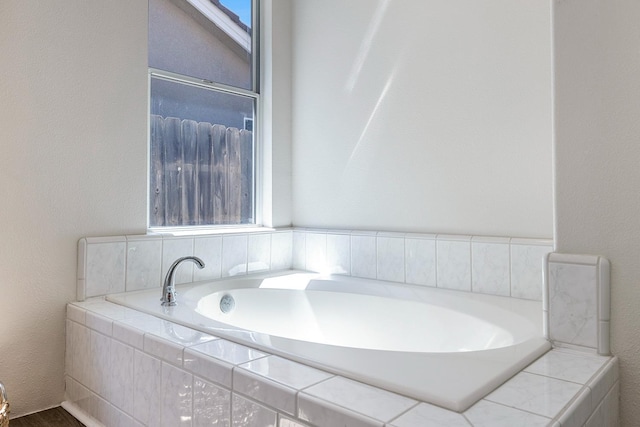 5642 W Beechwood Ave, Fresno, CA 93722 - bathroom featuring a bath and wood finished floors