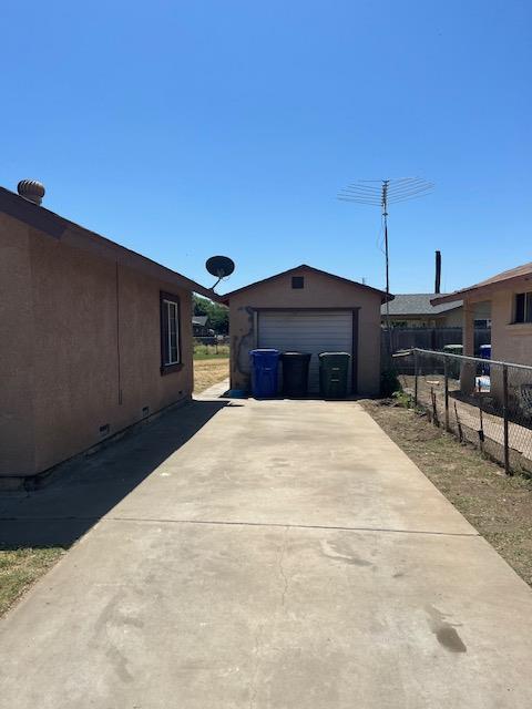 12895 School Ave, Cutler, CA 93615 - view of property exterior featuring an outbuilding, driveway, a detached garage, and crawl space