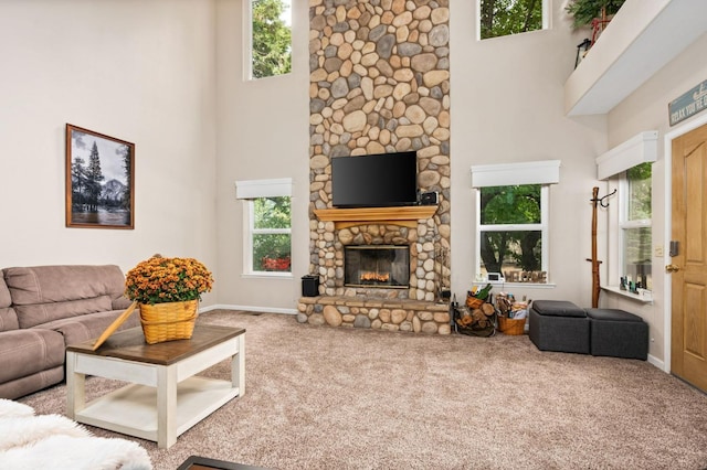 41208 Silver Pine Ln, Shaver Lake, CA 93664 - carpeted living area featuring a towering ceiling, healthy amount of natural light, a fireplace, and baseboards